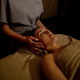 Relaxing spa treatment at Bowfield Hotel & Spa, a spa hotel near Glasgow, with a spa therapist giving a calming head and neck massage.