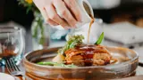 Gravy being poured onto food at the Ghillie restaurant