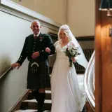 Bride and father walking down stairs in Cornhill Castle