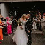 Couple kissing under confetti