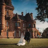 couple walking towards castle