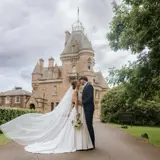 Couple kissing with Castle in the bakground