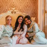 Bride and Bridesmaids sitting on bed