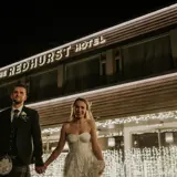 Couple standing in front of The Redhurst Hotel