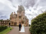 Couple celebrating being married at the front of Cornhill Castle