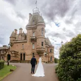 Couple celebrating being married at the front of Cornhill Castle