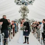 Couple kissing in the middle of the aisle