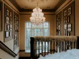 ornate hallway and banister with wedding floral arrangement