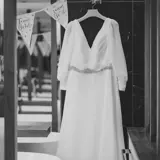 Brides dress hung up in hotel room