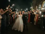 Couple walking through wedding party
