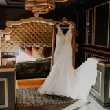 wedding dress hanging in honeymoon suite