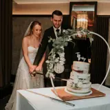 Couple getting ready to cut their cake