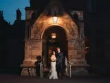Couple posing at night at the front entrance of the castle