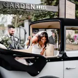 Couple getting into wedding car at The Garden House