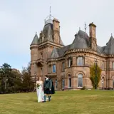 Couple standing infront of castle