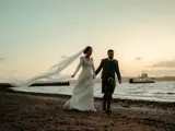 couple walking on beach at brisbane house largs wedding venue