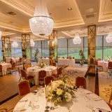 boclair dining hall arrangement for wedding with red chairs & white table linen