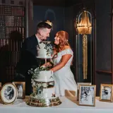 Couple cutting cake and looking at each other