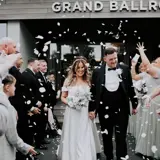 Couple walking through crowd with confetti